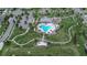 Aerial view of a community pool featuring lounge chairs and walkways with ample green space and parking at 11619 Cambium Crown Dr, Riverview, FL 33569