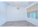 Bright dining room features wood floors, a chandelier, and a large window at 11619 Cambium Crown Dr, Riverview, FL 33569