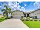 Charming single-story home with a well-manicured lawn and a spacious three car garage at 11619 Cambium Crown Dr, Riverview, FL 33569