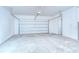 Empty garage featuring a white garage door and concrete floor at 11619 Cambium Crown Dr, Riverview, FL 33569