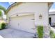 Garage featuring stone accents and dark metal decorative hardware at 11619 Cambium Crown Dr, Riverview, FL 33569