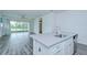 Open kitchen featuring a breakfast bar overlooking the living area and screened-in patio at 11619 Cambium Crown Dr, Riverview, FL 33569