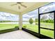 Relaxing screened lanai featuring tile floors and views of the expansive backyard and scenic lake at 11619 Cambium Crown Dr, Riverview, FL 33569
