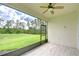 Inviting screened-in lanai with tile flooring and tranquil views of the grassy backyard at 11619 Cambium Crown Dr, Riverview, FL 33569