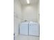 Laundry room featuring a washing machine and a dryer with overhead shelves at 11619 Cambium Crown Dr, Riverview, FL 33569