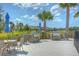 Community outdoor grilling area with stone-clad grills and blue umbrellas overlooking neighborhood homes at 11619 Cambium Crown Dr, Riverview, FL 33569