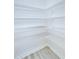 Pantry with white wire shelving and wood-look flooring at 11619 Cambium Crown Dr, Riverview, FL 33569