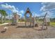 View of an elaborate wooden playground structure with slides, swings, and climbing features at 11619 Cambium Crown Dr, Riverview, FL 33569