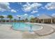 Community pool featuring a splash pad, resort-style seating, and a covered picnic area with lush landscaping at 11619 Cambium Crown Dr, Riverview, FL 33569