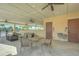 An outdoor veranda with ceiling fans featuring cushioned seating and tables near restrooms and water fountains at 11619 Cambium Crown Dr, Riverview, FL 33569