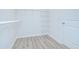Walk-in closet with wood-look flooring and white wire shelving at 11619 Cambium Crown Dr, Riverview, FL 33569
