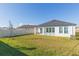 Spacious backyard featuring lush lawn and a covered patio, perfect for relaxing or entertaining outdoors at 11717 74Th E Cir, Palmetto, FL 34221
