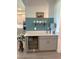Stylish bar area with a built-in wine fridge, counter space, and decorative accents at 11717 74Th E Cir, Palmetto, FL 34221