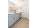 Modern bathroom featuring double vanity, neutral tile flooring, and granite countertops at 11717 74Th E Cir, Palmetto, FL 34221