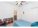 Cozy bedroom with ceiling fan, bookcase, closet and an adjoining bathroom for added privacy and convenience at 11717 74Th E Cir, Palmetto, FL 34221