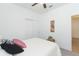 Bright bedroom with a white quilt bed, ceiling fan, and closet, perfect for relaxing and unwinding at 11717 74Th E Cir, Palmetto, FL 34221