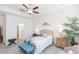 Bright bedroom with ensuite bathroom access, ceiling fan, and tropical bedding at 11717 74Th E Cir, Palmetto, FL 34221