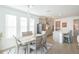 Sunlit dining area with modern chandelier, open to the kitchen, perfect for entertaining at 11717 74Th E Cir, Palmetto, FL 34221