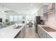 Open-concept kitchen featuring a large island, stainless steel appliances, and seamless flow to the dining and living areas at 11717 74Th E Cir, Palmetto, FL 34221