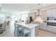 Bright, open kitchen featuring stainless steel appliances, quartz countertops, and an island with bar seating at 11717 74Th E Cir, Palmetto, FL 34221
