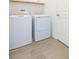 Bright laundry room featuring a modern washer and dryer, cabinets and stylish tile floors at 11717 74Th E Cir, Palmetto, FL 34221