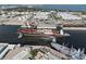 This aerial showcases a harbor with large ships and industrial facilities, highlighting waterfront activity and infrastructure at 1209 E Cumberland Ave # 604, Tampa, FL 33602