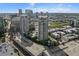 An aerial view shows a condo with city skyline backdrop, pool, parking garage, and well maintained landscaping at 1209 E Cumberland Ave # 604, Tampa, FL 33602