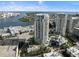 An aerial view highlights a waterfront condominium with a swimming pool, lush landscaping, and cityscape views at 1209 E Cumberland Ave # 604, Tampa, FL 33602