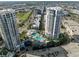 An aerial view displays a luxury condo with a pool, lush landscaping, and parking garage at 1209 E Cumberland Ave # 604, Tampa, FL 33602