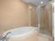 Bright bathroom featuring a soaking tub and a glass-enclosed shower at 1209 E Cumberland Ave # 604, Tampa, FL 33602
