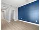 Bedroom featuring wood floors and a deep blue accent wall at 1209 E Cumberland Ave # 604, Tampa, FL 33602
