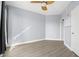 Bright bedroom features light blue walls, modern ceiling fan, and light wood-look flooring at 1209 E Cumberland Ave # 604, Tampa, FL 33602