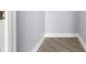Neutral gray walls and a white baseboard highlight the corner of the light-filled room at 1209 E Cumberland Ave # 604, Tampa, FL 33602