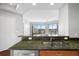 Kitchen featuring granite countertops and a view of the living room at 1209 E Cumberland Ave # 604, Tampa, FL 33602