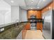 Well-equipped kitchen featuring stainless steel appliances, granite counters, and ample cabinet space at 1209 E Cumberland Ave # 604, Tampa, FL 33602