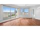 Open living area featuring gleaming hardwood floors, neutral paint, and large windows showcasing city views at 1209 E Cumberland Ave # 604, Tampa, FL 33602