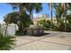 A stainless steel outdoor grill area, perfect for entertaining, surrounded by mature palm trees and a beautifully landscaped patio at 1209 E Cumberland Ave # 604, Tampa, FL 33602
