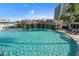 Tranquil swimming pool area with a rock waterfall, clear blue water, and comfortable lounge seating at 1209 E Cumberland Ave # 604, Tampa, FL 33602