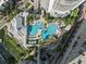 Overhead shot of the beautifully landscaped community pool featuring ample lounge seating and lush tropical greenery at 1209 E Cumberland Ave # 604, Tampa, FL 33602