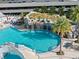Outdoor pool showcasing a rock waterfall feature, clear water, and lounge chairs for relaxation at 1209 E Cumberland Ave # 604, Tampa, FL 33602