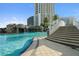 Beautiful outdoor pool with waterfall feature, steps for access, and high-rise building views at 1209 E Cumberland Ave # 604, Tampa, FL 33602