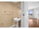 Well-lit powder room with pedestal sink, large mirror and stylish towel bar at 1209 E Cumberland Ave # 604, Tampa, FL 33602