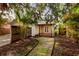 The backyard features a wood deck, lush landscaping, and a stone path at 121 28Th N Ave, St Petersburg, FL 33704