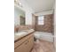 Bathroom featuring granite countertop vanity, shower, tub, and tile accents for a luxurious feel at 121 28Th N Ave, St Petersburg, FL 33704