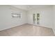 Well-lit bedroom boasting tile floors and glass paneled doors with a view to the outside at 121 28Th N Ave, St Petersburg, FL 33704