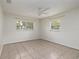 Bright bedroom with tile flooring, ceiling fan, and two windows for ample natural light at 121 28Th N Ave, St Petersburg, FL 33704
