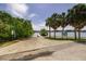 Concrete boat ramp with palm trees and informational signs, offering water access at 121 28Th N Ave, St Petersburg, FL 33704