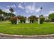 A manicured entrance with decorative pergolas, flowers, and lush landscaping at 121 28Th N Ave, St Petersburg, FL 33704