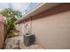 Beige block wall exterior shows AC unit, door, and small rocks along the side of the house at 121 28Th N Ave, St Petersburg, FL 33704