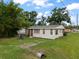 Charming single-story home featuring a cozy front porch, a well-maintained lawn, and a classic design in a quiet neighborhood at 12324 Pittsfield Ave, Tampa, FL 33624